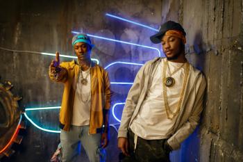 Two black rappers, perfomance in club with neon lights on background. Rap performers in subway, underground music concert, urban style