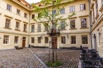 Ancient building facade and yard, old European town. Summer tourism and travels, famous europe landmark, popular places and streets