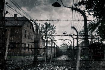 Barracks and barbed wire fence, German death camp Auschwitz II, Birkenau, Poland. Museum of victims of the nazi genocide of the Jewish people
