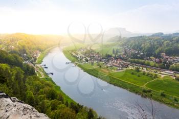 Germany, provincial town in green forest on Elbe river, view from mountain. Buildings in old european style, German architecture