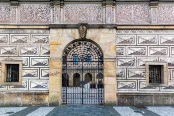 Ancient building facade with gates, old European town. Summer tourism and travels, famous europe landmark, popular places and streets