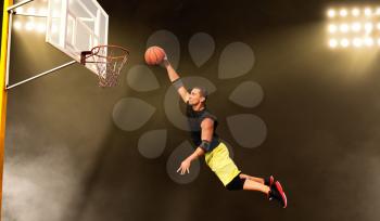 Basketball player makes a throw, shoot in action, dark background. Male athlete in sportswear scores on streetball training