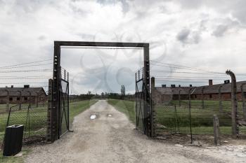 Gates and barbed wire fence, German concentration camp Auschwitz II, Poland. Museum of victims of the nazi genocide of the Jewish people