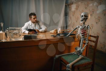 Male psychiatrist and the patient skeleton, mental hospital. Doctor in clinic for the mentally ill