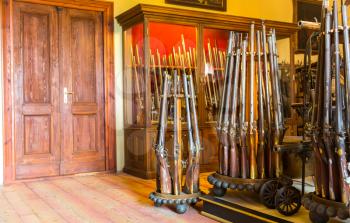 Room with old weapons, ancient armory storage, Europe. Medieval european guns, famous places for travel and tourism