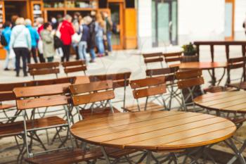 Wooden tables in outdoor cafe, Karlovy Vary, Czech Republic, Europe. Old european town, famous place for travel and tourism