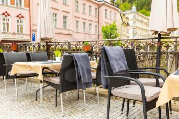 Cosy outdoor cafe with rattan furniture, Karlovy Vary, Czech Republic, Europe. Old european town, famous place for travel