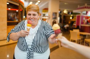 Fat woman buying two ice creams in fastfood mall restaurant. Overweight female person with ice-cream, obesity problem