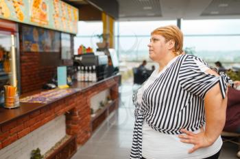 Fat woman at the fast food restaurant menu. Overweight female person buying fastfood, obesity problem
