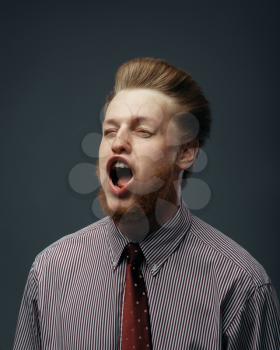 Strong wind blowing in male face, funny emotion. Powerful air flow blows on businessman on black background