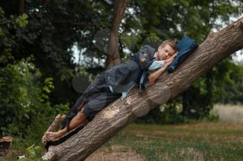 Tired businessman in torn suit sleeping on the tree on desert island. Business risk, collapse or bankruptcy concept