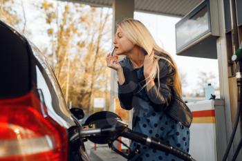 Woman fuels vehicle on gas station, fuel filling. Petrol fueling, gasoline or diesel refuel service,