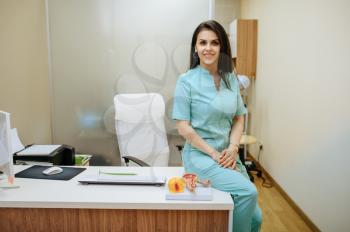 Female gynecologist sitting at the clinic office. Gynecological examination or consultation, gynecology office. Doctor in hospital