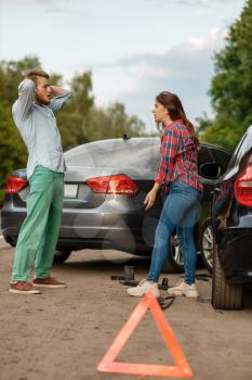 Car accident on road, man and woman are sorted out. Automobile crash, emergency stop sign. Broken automobile or damaged vehicle, auto collision on highway