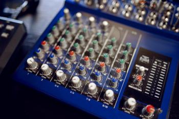 Mixing console closeup, recording studio equipment, nobody. Professional audio mixer panel, sound engineer or musician workplace, soundboard