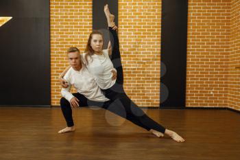 Contemporary dance performers, couple posing in studio. Male and female dancers on workout in class, modern dancing, stretching exercise