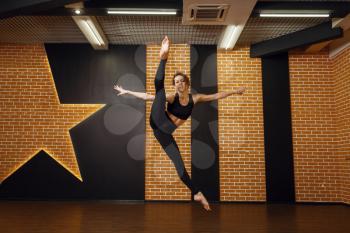 Female contemporary dance performer, jump in motion, training in studio. Dancer on workout in class, modern ballet, elegance dancing, stretching exercise