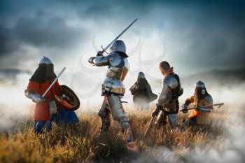 Medieval battle of knights in armor and helmets with swords and axes, great combat. Armored ancient warriors