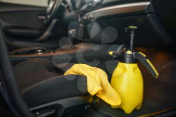 Vehicle interior, rag and spray, car wash service, nobody. Automobile on carwash station, car-wash business concept