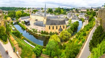 Luxembourg cityscape, ancient church on river, panorama. Old european architecture, medieval stone buildings