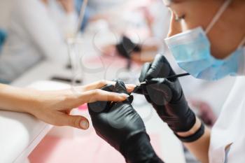 Master in gloves works with nails, manicure procedure in beauty salon. Professional beautician and female customers, fingernail care in spa studio, hands treatment
