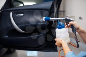 Female washer cleans automobile interior, car wash. Woman washes vehicle, carwash station, car wash business