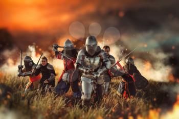 Medieval knights in armor and helmets with swords and axes on battle field, great combat. Armored ancient warriors