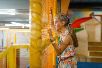 Adorable little girl playing in kids labyrinth, playground in entertainment center. Play area indoors, playroom