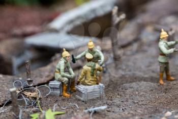 The military of the early 20th century at a halt near the trenches, soldiers, miniature scene outdoor, europe. Mini figures with high detaling of objects, realistically diorama, toy model