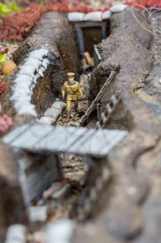 Soldier in trench, miniature scene outdoor, europe. Mini figures with high detaling of objects, realistically diorama, toy model
