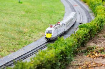 The train goes by railway, miniature scene outdoor, europe. Mini figures with high detaling of objects, realistically diorama
