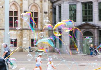 Children and soap bubbles, old European town. Summer tourism and travels, famous europe landmark, popular places for travelling