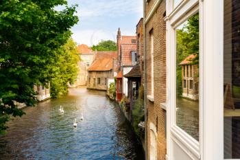 Ancient building facades on river canal in old tourist town, Europe. European city, famous place for travel and tourism, traditional architecture