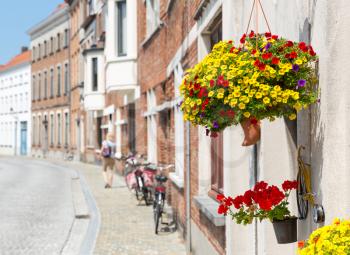 Bicycles at ancient building facade on cozy street, old provincial European town. Summer tourism and travels, famous europe landmark, popular places