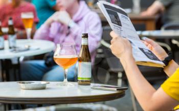 People drinks beer in street cafe in old European tourist town. Summer tourism and travels, famous europe landmark, popular places for travelling