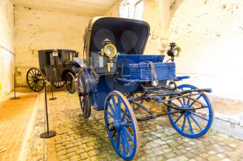 Vintage carriages in museum, old vehicle, Europe. Traditional european architecture, famous places for tourism and travel, historical heritage