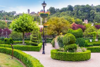 Bushes in different shapes, summer park in Europe. Professional gardening, european green landscape, garden plants decoration