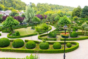 Bushes in different shapes, summer park in Europe. Professional gardening, european green landscape, garden plants decoration