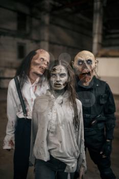 Three zombies in abandoned factory, scary place. Horror in city, creepy crawlies attack, doomsday apocalypse, bloody evil monsters