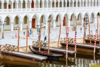 Ancient boat at the pier, people walk on the shore, miniature scene outdoor, europe. Mini figures with high detaling of objects, realistically diorama, toy model