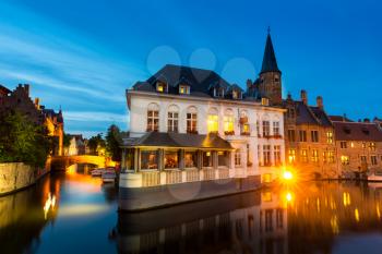 Belgium, Brugge, old European town with buildings on river, night view. Tourism and travels, famous europe landmark