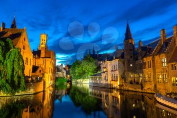 Belgium, Brugge, ancient European town with stone buildings on river, night view, glassy water surface. Tourism and travels, famous europe landmark, popular places, West Flanders