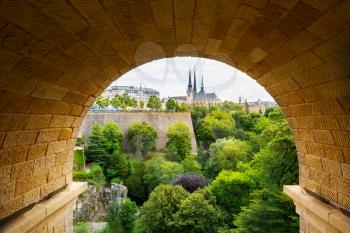 View of old european city through the stone arch. Summer tourism and travels, famous europe landmark, popular places for vacation tour or holidays