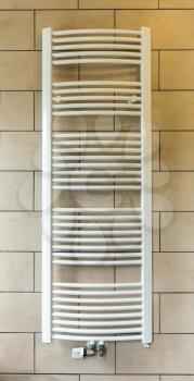 Heated towel rail in hotel bathroom closeup, Europe tourism. European motel furniture for personal hygiene, apartment for comfortable leisure, nobody