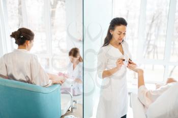 Manicure masters applies nail polish to woman, beauty salon. Professional beautician and female customer, fingernail care in spa studio
