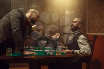 Poker player grabbed his opponent's tie, sharper in casino, risk. Games of chance addiction. Men with whiskey and cigars in gambling house