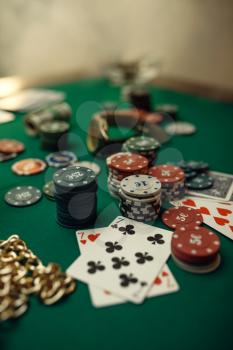Poker concept, cards and chips on gaming table closeup, whiskey and cigar in casino, nobody. Games of chance. Gambling house business