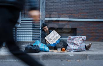 Beggar man lost all in his life, poor on city street. Poverty is a social problem, homelessness and loneliness, alcoholism and drunk addiction, urban lonely
