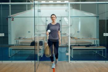 Happy female player with squash racket in locker room. Girl on game training, active sport hobby, fit workout for healthy lifestyle