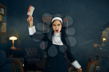 Young crazy nun in a cassock holds bloody knife, vicious desires. Corrupt sister in the monastery, religion and faith, sinful religious people, attractive sinner
